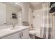 Well-lit bathroom featuring a shower-tub combo, white tile, and modern fixtures at 4343 E 96Th Way, Thornton, CO 80229