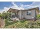 Back exterior view of home with covered patio and well-maintained lawn at 4343 E 96Th Way, Thornton, CO 80229