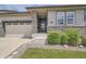 Inviting home featuring stone accents, a covered entry and well-manicured landscaping at 4343 E 96Th Way, Thornton, CO 80229