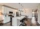 Open kitchen with modern appliances, white cabinetry and a large center island with barstool seating at 4343 E 96Th Way, Thornton, CO 80229