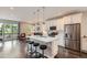 Bright kitchen featuring stainless steel appliances, white cabinetry and a spacious breakfast bar at 4343 E 96Th Way, Thornton, CO 80229