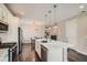 Bright and open kitchen with stainless steel appliances, white cabinetry, and a large center island at 4343 E 96Th Way, Thornton, CO 80229