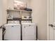 Functional laundry room with a white washer and dryer and extra shelf storage at 4343 E 96Th Way, Thornton, CO 80229