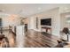 Open-concept living room featuring a kitchen island, dark floors, and a large entertainment area at 4343 E 96Th Way, Thornton, CO 80229