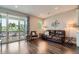 Inviting living room with a sliding glass door to a deck, dark floors and modern decor at 4343 E 96Th Way, Thornton, CO 80229