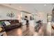Open living space with a modern kitchen, dark floors and bright white kitchen cabinets at 4343 E 96Th Way, Thornton, CO 80229