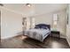 Bright main bedroom with wood floors, neutral walls, and an ensuite bathroom at 4343 E 96Th Way, Thornton, CO 80229