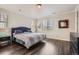 Bright main bedroom featuring wood floors, neutral walls, and two windows with blinds at 4343 E 96Th Way, Thornton, CO 80229