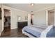 Spacious main bedroom featuring dark floors, neutral walls, walk-in closet and ensuite bathroom at 4343 E 96Th Way, Thornton, CO 80229