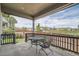 Covered patio with wrought iron chairs and table with a view of community green space at 4343 E 96Th Way, Thornton, CO 80229