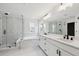 Primary bathroom featuring dual sinks, soaking tub and glass shower at 5537 Riverbend Ave, Firestone, CO 80504