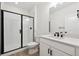 Modern bathroom with white cabinets and large glass shower at 5537 Riverbend Ave, Firestone, CO 80504