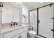 Beautiful bathroom featuring a shower with glass door and white sink at 5537 Riverbend Ave, Firestone, CO 80504