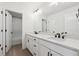 Modern bathroom with dual sinks and white cabinets at 5537 Riverbend Ave, Firestone, CO 80504
