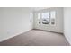 Bright, carpeted bedroom featuring large windows at 5537 Riverbend Ave, Firestone, CO 80504