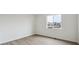 This bedroom has neutral walls, light wood floors, one window, and baseboard trim throughout at 5537 Riverbend Ave, Firestone, CO 80504