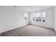 Bright, carpeted bedroom with large windows at 5537 Riverbend Ave, Firestone, CO 80504