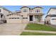 Inviting two-story home featuring a well-manicured lawn and a convenient two-car garage at 5537 Riverbend Ave, Firestone, CO 80504