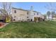 Spacious backyard with a large lawn, partial fencing and a patio at 3121 S Estes St, Lakewood, CO 80227