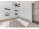 Bright bedroom featuring neutral carpet, a ceiling fan, two windows and built in closet at 3121 S Estes St, Lakewood, CO 80227