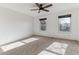 Bright bedroom featuring neutral carpet, a ceiling fan, and large windows offering plenty of natural light at 3121 S Estes St, Lakewood, CO 80227