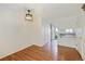 Dining room with hardwood floors and modern lighting fixture that flows into the kitchen at 3121 S Estes St, Lakewood, CO 80227