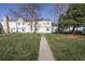 Inviting townhouse with a pathway leading to a well-manicured lawn and appealing exterior at 3121 S Estes St, Lakewood, CO 80227