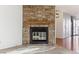 Close up on a stone fireplace with a wooden mantel, providing a cozy focal point in the living area at 3121 S Estes St, Lakewood, CO 80227