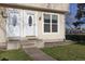 Charming townhouse featuring well-maintained front entrance with a decorative door and a green lawn at 3121 S Estes St, Lakewood, CO 80227
