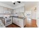 Kitchen features granite countertops, white appliances, and opens to the sunlit living room at 3121 S Estes St, Lakewood, CO 80227