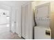 Convenient laundry area with a stacked washer and dryer near the hallway at 3121 S Estes St, Lakewood, CO 80227