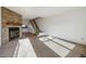 Inviting living room with stone fireplace, carpeted floors, and open staircase at 3121 S Estes St, Lakewood, CO 80227