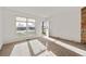 Bright living room features large window, front door, and cozy carpet flooring at 3121 S Estes St, Lakewood, CO 80227