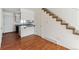 Bright living room boasts hardwood floors that lead to the modern kitchen and staircase at 3121 S Estes St, Lakewood, CO 80227