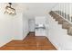 Bright living room boasts hardwood floors that lead to the modern kitchen, staircase, and front door at 3121 S Estes St, Lakewood, CO 80227