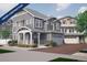 Charming gray home with covered porch, manicured landscaping and a two-car garage at 1169 Highview Dr, Erie, CO 80516