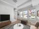 Bright living room with large windows, hardwood floors, and modern decor, creating a welcoming atmosphere at 1169 Highview Dr, Erie, CO 80516