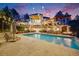 Stunning backyard featuring a large swimming pool, a meticulously landscaped lawn, and an illuminated home at dusk at 10914 Remmick Ridge Rd, Parker, CO 80134