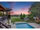 Beautiful outdoor backyard features a large yard, pool, and a scenic sunset view at 10914 Remmick Ridge Rd, Parker, CO 80134