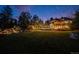 Large backyard with lawn and custom waterfall feature leading to an inviting pool and outdoor entertainment area at 10914 Remmick Ridge Rd, Parker, CO 80134