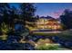 Captivating backyard featuring a koi pond, pool, firepit, and extensive landscaping for relaxing evenings at 10914 Remmick Ridge Rd, Parker, CO 80134