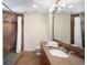A tiled bathroom features a glass shower, modern lighting, and a vanity sink with plenty of counter space for comfortable use at 10914 Remmick Ridge Rd, Parker, CO 80134
