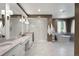 Serene bathroom featuring a soaking tub, walk-in shower, double vanity with marble countertop, and modern lighting at 10914 Remmick Ridge Rd, Parker, CO 80134