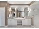 Modern bathroom featuring dual vanities, a large mirror with sconces, sleek finishes, and a walk-in shower at 10914 Remmick Ridge Rd, Parker, CO 80134