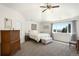 Bright bedroom featuring a vaulted ceiling, ceiling fan, and large window with scenic views overlooking the surrounding landscape at 10914 Remmick Ridge Rd, Parker, CO 80134