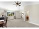 A sprawling bedroom with a ceiling fan, a large closet, and a window that provides generous natural light and tree top views at 10914 Remmick Ridge Rd, Parker, CO 80134