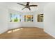 Bright bonus room featuring many windows and hardwood flooring, providing natural light and an inviting atmosphere at 10914 Remmick Ridge Rd, Parker, CO 80134