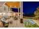 Outdoor deck featuring ample seating, a dining area, a cooking area, and a swimming pool at 10914 Remmick Ridge Rd, Parker, CO 80134