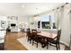 Elegant dining room featuring a large wooden table, chandelier, and natural light, seamlessly connecting to the living area at 10914 Remmick Ridge Rd, Parker, CO 80134