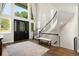 Welcoming foyer with a dark door, soaring windows, staircase, and wood floors offering style and sophistication at 10914 Remmick Ridge Rd, Parker, CO 80134